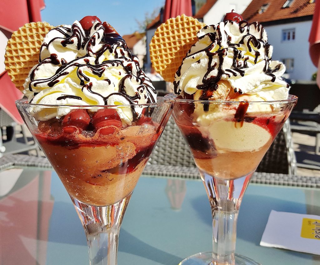 Two Ice Cream coupes served during a sunny day.
