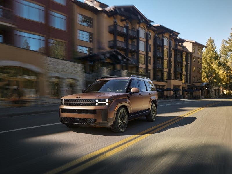 Hyundai Santa Fe driving through a downtown street