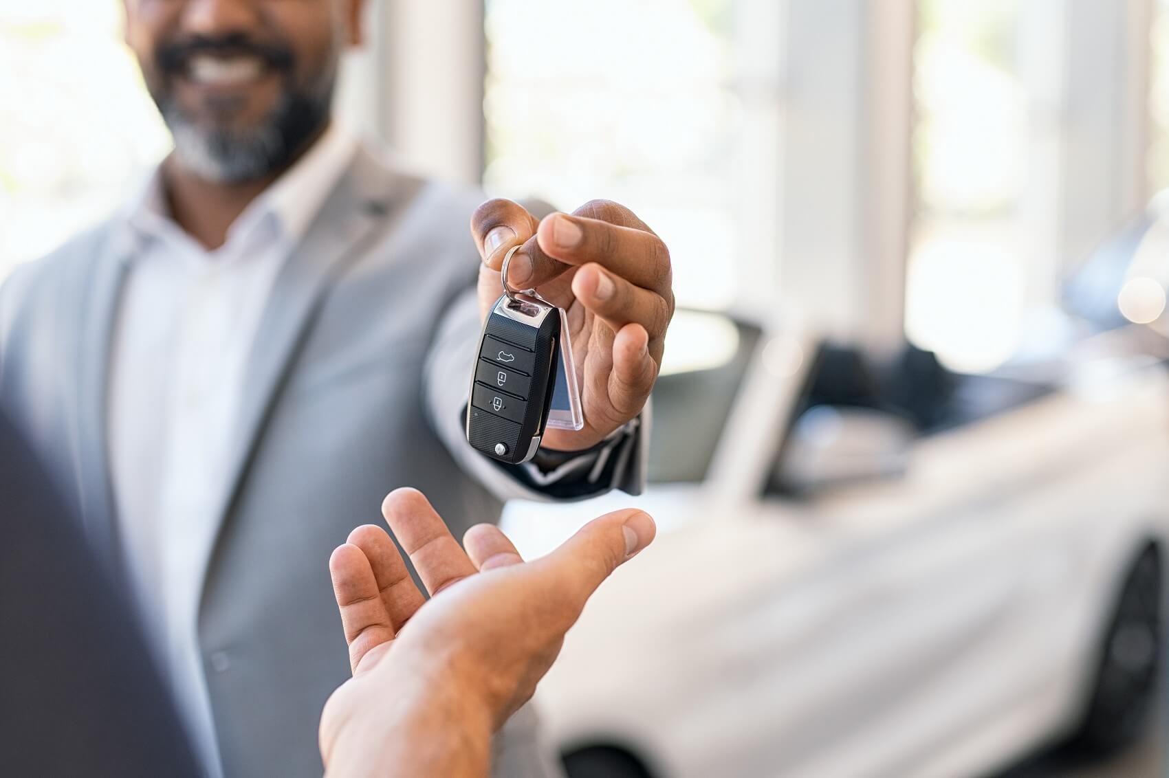 sales manager giving keys to customer for new Hyundai